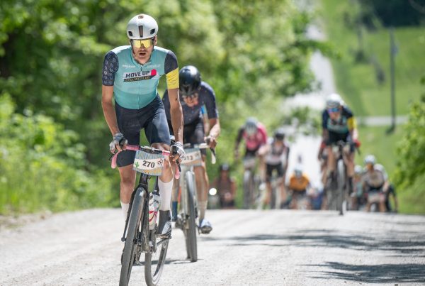 Move Up Cycling Club rider leading a gravel race group uphill